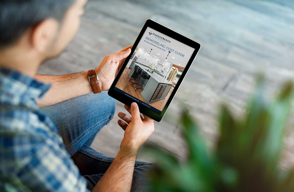 Man reading Home Remodeling Cost Guide on his tablet